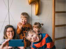 mom taking selfie with three kids