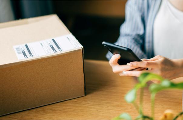 woman prepares to ship phone in box
